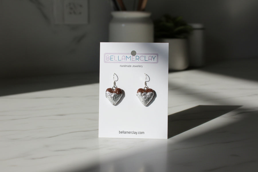 Heart-shaped earrings on a Bellamerclay branded card against a plain background